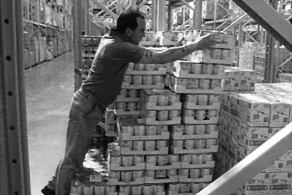 operative reaching to reach the rear of a sloped storage stack